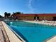 Sparkling community pool with surrounding patio furniture at 4104 Catalina Dr, Bradenton, FL 34210