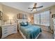 Cozy bedroom with a white dresser and teal bedding at 4106 Central Sarasota Pkwy # 1026, Sarasota, FL 34238