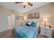 Well-lit bedroom with a comfortable bed and ensuite bathroom access at 4106 Central Sarasota Pkwy # 1026, Sarasota, FL 34238