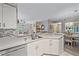 Kitchen features double sink, dishwasher, and view to dining area at 4106 Central Sarasota Pkwy # 1026, Sarasota, FL 34238