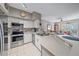 Open concept kitchen with stainless steel appliances and breakfast bar at 4106 Central Sarasota Pkwy # 1026, Sarasota, FL 34238
