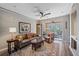 Living room with leather sofa, balcony access, and decorative rug at 4106 Central Sarasota Pkwy # 1026, Sarasota, FL 34238