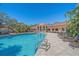Community pool with lounge chairs and surrounding landscaping at 4106 Central Sarasota Pkwy # 1026, Sarasota, FL 34238