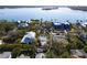 An aerial shot showcasing a house near the water, surrounded by other homes and greenery at 4189 Roberts Point Cir, Sarasota, FL 34242