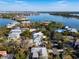Aerial view showing a house by the water with nearby houses and lush surroundings at 4189 Roberts Point Cir, Sarasota, FL 34242
