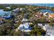 An aerial view of a house situated amongst other homes near a canal at 4189 Roberts Point Cir, Sarasota, FL 34242