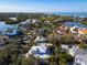 Aerial view of a waterfront property with lush landscaping and neighboring homes at 4189 Roberts Point Cir, Sarasota, FL 34242