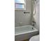 Bathroom with a shower/tub combo and tiled walls at 4480 Ironwood Cir # 218A, Bradenton, FL 34209