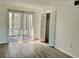 Bedroom with wood-look floors and sliding door to balcony at 4480 Ironwood Cir # 218A, Bradenton, FL 34209