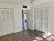 Bedroom with wood-look floors and double closets at 4480 Ironwood Cir # 218A, Bradenton, FL 34209