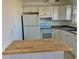 White kitchen with butcher block countertop and appliances at 4480 Ironwood Cir # 218A, Bradenton, FL 34209