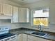 White kitchen with granite countertops and appliances at 4480 Ironwood Cir # 218A, Bradenton, FL 34209