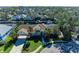 Aerial view of waterfront home with lush landscaping and driveway at 4712 Compass Dr, Bradenton, FL 34208