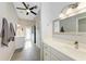 Bathroom with a double vanity, walk-in shower, and a door to backyard at 4712 Compass Dr, Bradenton, FL 34208
