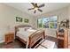 Guest bedroom with a queen bed, wood floors, and a view of the backyard at 4712 Compass Dr, Bradenton, FL 34208