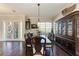 Formal dining room with dark wood table and hutch, hardwood floors, and access to kitchen at 4712 Compass Dr, Bradenton, FL 34208