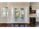 Bright entryway with double doors, hardwood floors, and wine fridge at 4712 Compass Dr, Bradenton, FL 34208