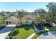 Single-Gathering home with a large yard, driveway, and walkway at 4712 Compass Dr, Bradenton, FL 34208