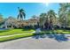 Tan house with palm trees, walkway, and driveway at 4712 Compass Dr, Bradenton, FL 34208