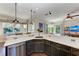 Open kitchen with breakfast bar, stainless steel appliances, and pool view at 4712 Compass Dr, Bradenton, FL 34208