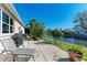 Relaxing patio with lounge chair and grill, overlooking canal at 4712 Compass Dr, Bradenton, FL 34208