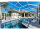 Inviting pool area with screened enclosure, and tiled deck at 4712 Compass Dr, Bradenton, FL 34208
