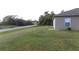 House side yard with grassy lawn at 5271 Beckham St, North Port, FL 34288