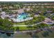 Aerial view of community pool, clubhouse, and tennis courts at 5762 Benevento Dr, Sarasota, FL 34238