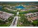 Aerial view of a luxurious community with a lake at 5762 Benevento Dr, Sarasota, FL 34238