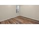 Well-lit bedroom featuring wood floors and window at 5762 Benevento Dr, Sarasota, FL 34238