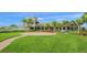 Community clubhouse with landscaped grounds at 5762 Benevento Dr, Sarasota, FL 34238