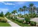 Landscaped community entrance with palm trees and a paved walkway at 5762 Benevento Dr, Sarasota, FL 34238