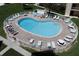 Kidney shaped community pool with plenty of lounge chairs at 5830 Midnight Pass Rd # 406, Sarasota, FL 34242