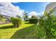 Landscaped backyard with lush greenery and spacious lawn at 6001 Cedarwood Ln, Bradenton, FL 34203