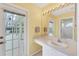Guest bathroom with vanity, single sink, and access to the pool area at 6001 Cedarwood Ln, Bradenton, FL 34203