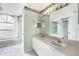 Double vanity bathroom with large mirror and updated fixtures at 6001 Cedarwood Ln, Bradenton, FL 34203