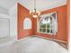 Bright dining room with an arched window and a chandelier at 6001 Cedarwood Ln, Bradenton, FL 34203