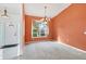 Dining room with orange walls, a chandelier, and a view to the outside at 6001 Cedarwood Ln, Bradenton, FL 34203