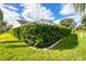 Neatly trimmed hedge providing privacy and curb appeal at 6001 Cedarwood Ln, Bradenton, FL 34203