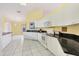 Kitchen boasts white cabinets, granite countertops and tile flooring at 6001 Cedarwood Ln, Bradenton, FL 34203
