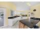 Kitchen features white cabinets, granite countertops, and yellow walls at 6001 Cedarwood Ln, Bradenton, FL 34203