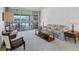 Living room features floral patterned sofa and easy access to the lanai at 6001 Cedarwood Ln, Bradenton, FL 34203