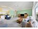 Open living room and kitchen with neutral walls, ceiling fan and comfy seating at 6001 Cedarwood Ln, Bradenton, FL 34203