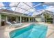 Relaxing screened pool with lounge chairs and a spacious patio at 6001 Cedarwood Ln, Bradenton, FL 34203
