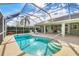 Refreshing screened pool with lounge chairs and a spacious patio at 6001 Cedarwood Ln, Bradenton, FL 34203