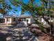 White house exterior with lush landscaping and a pathway at 611 Hibiscus Way, Longboat Key, FL 34228