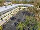 Aerial view of condo building and parking lot at 6703 Midnight Pass Rd # 117, Sarasota, FL 34242