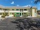 Exterior view of condo building, showing parking and individual unit entrance at 6703 Midnight Pass Rd # 117, Sarasota, FL 34242