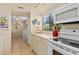 Bright kitchen features white appliances and ample counter space at 6703 Midnight Pass Rd # 117, Sarasota, FL 34242