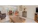 Living room with comfortable seating and access to a screened patio at 6703 Midnight Pass Rd # 117, Sarasota, FL 34242